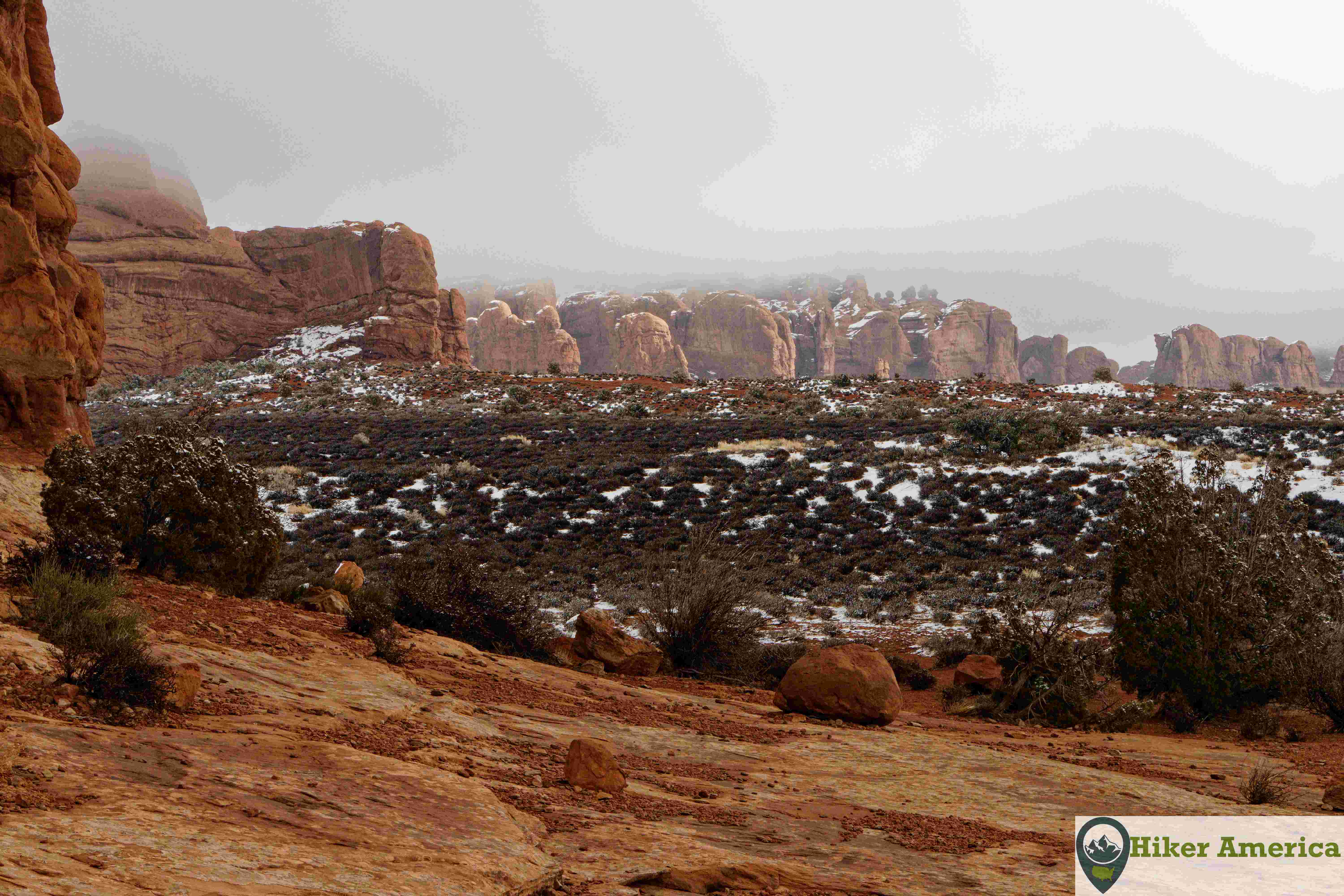 Snowy view of red rocks.